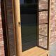 Restored antique oak display cabinet, black background, glass shelves.
