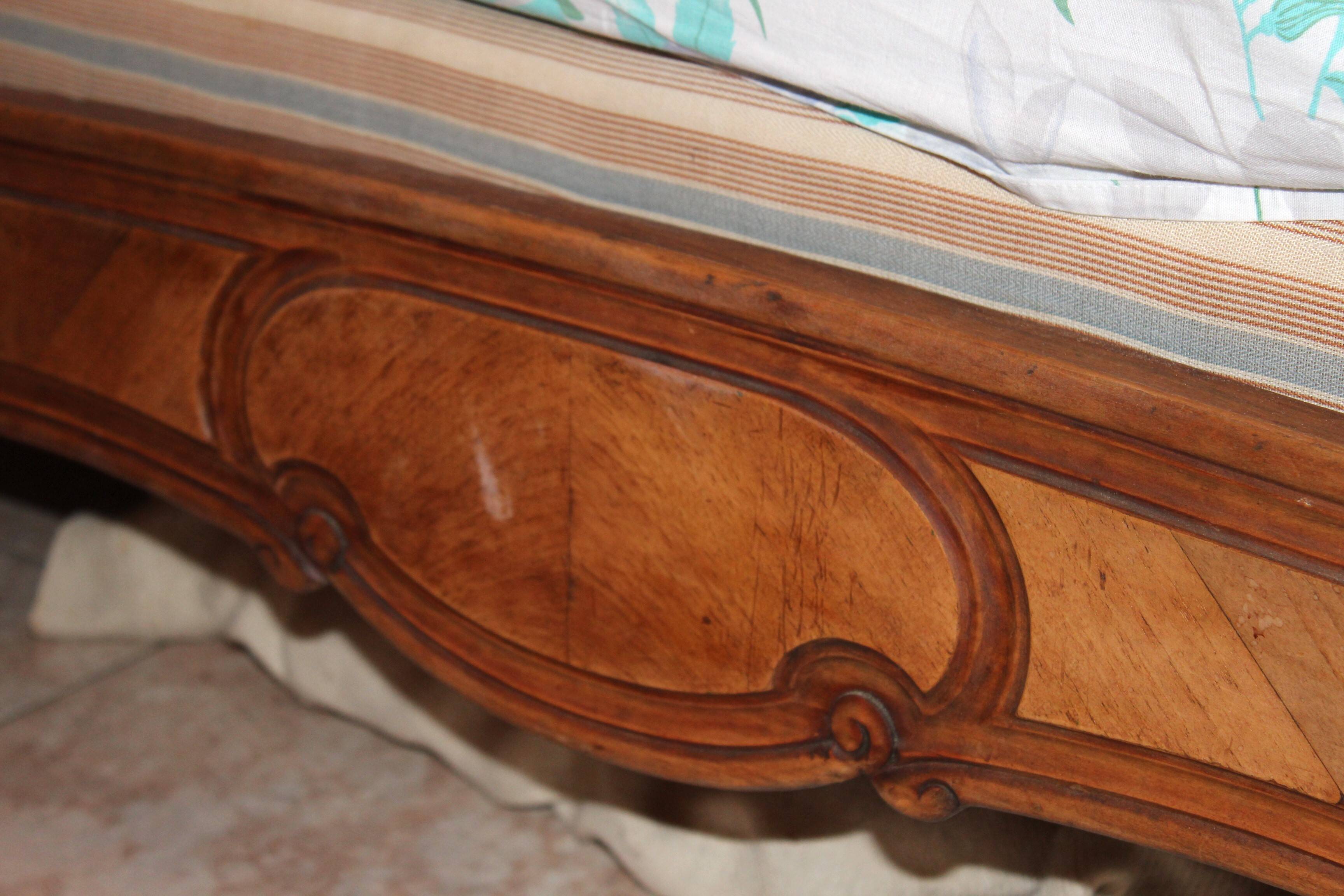 Walnut rocaille bed from the early 20th century.
