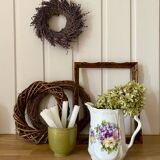 Old ceramic pitcher decorated with flowers