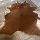 Brown and white cow rug