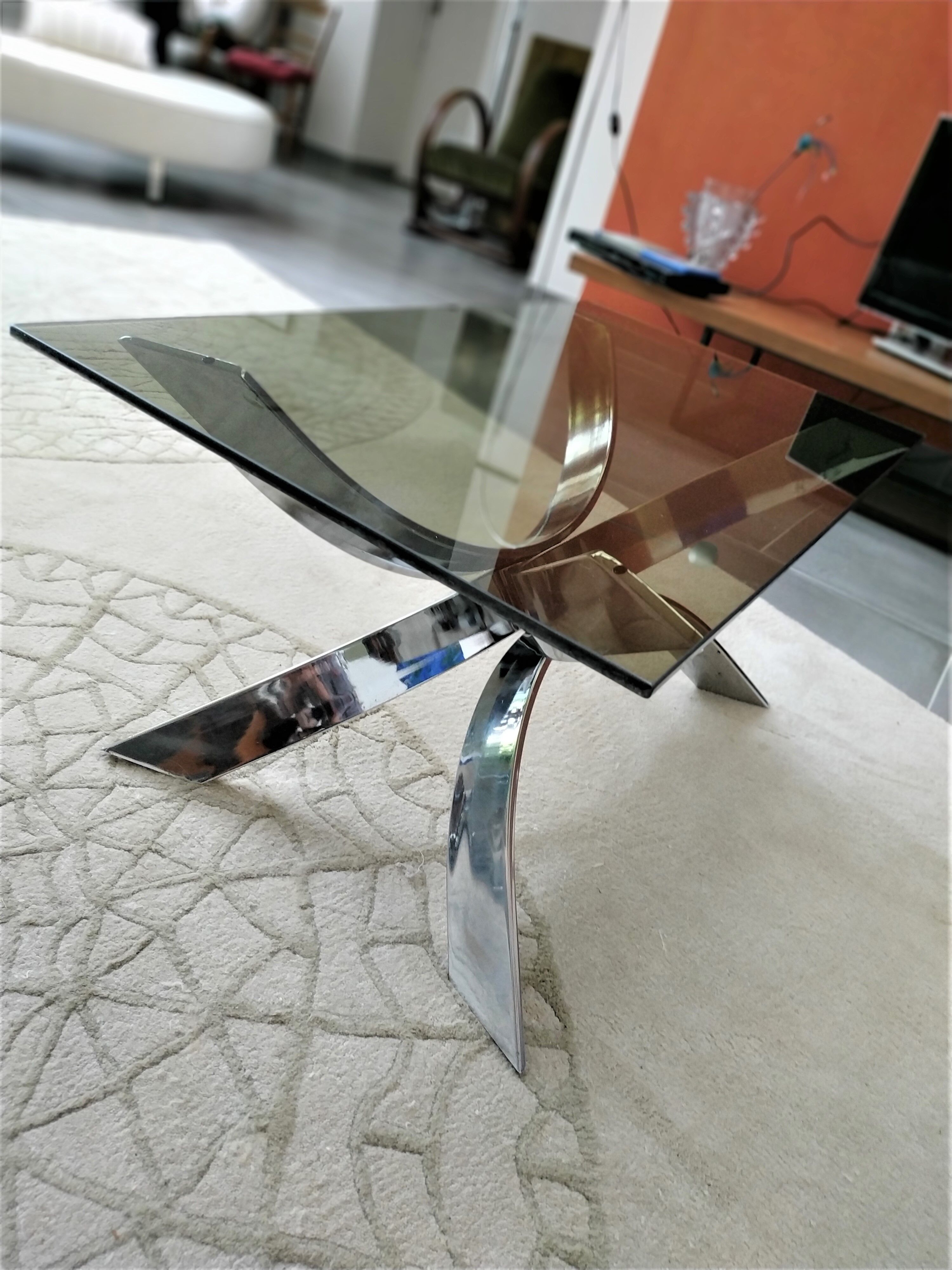 A chrome-shaped table and a 70s glass tray