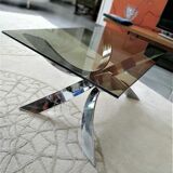 A chrome-shaped table and a 70s glass tray