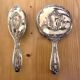 Silver metal hand mirror and laundry brush
