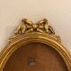 Golden oval wooden frame