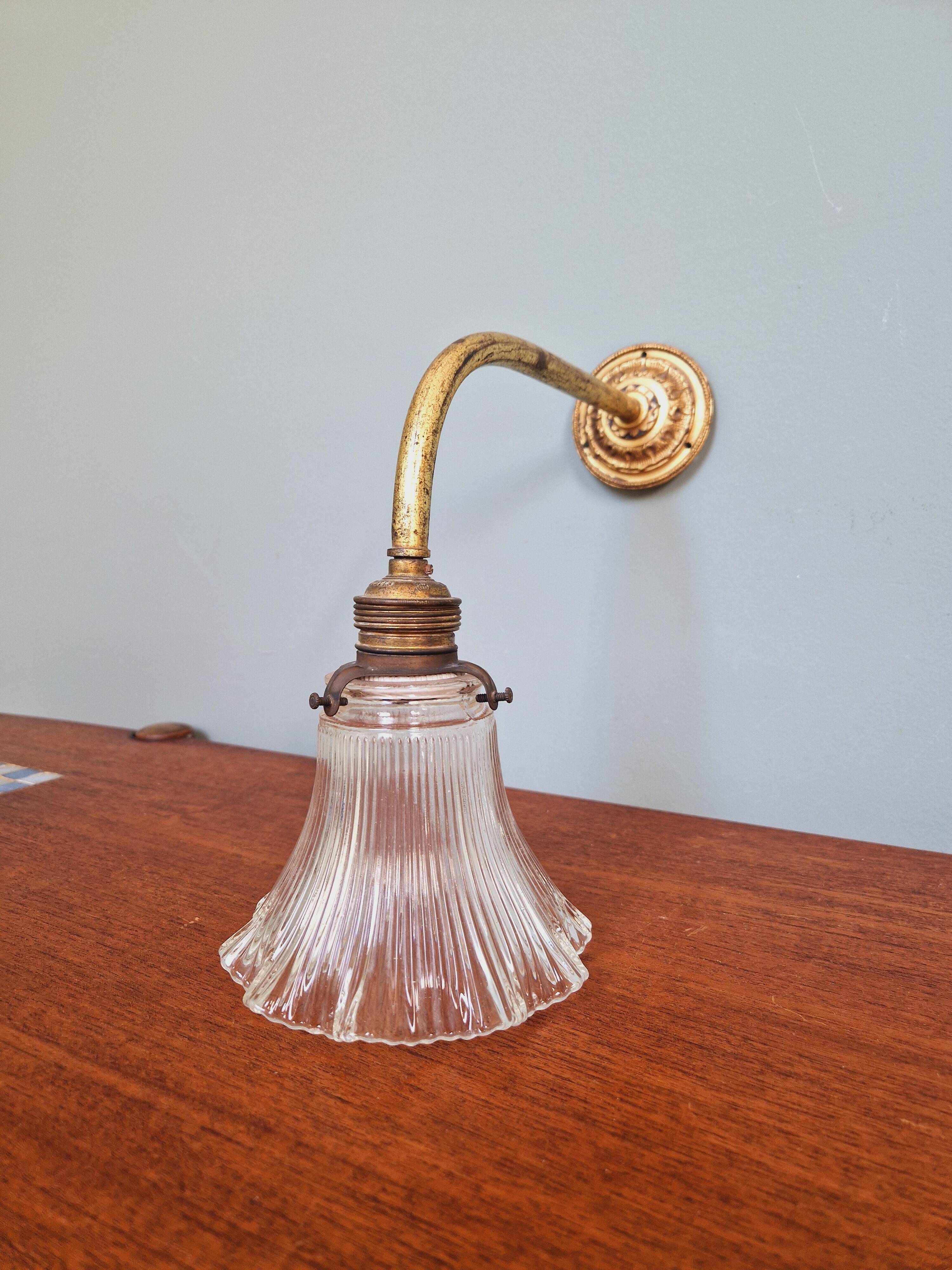 Bronze wall light with grooved clear glass, early 20th century