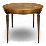 Louis XVI style dining table with a leather top.