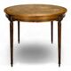 Louis XVI style dining table with a leather top.