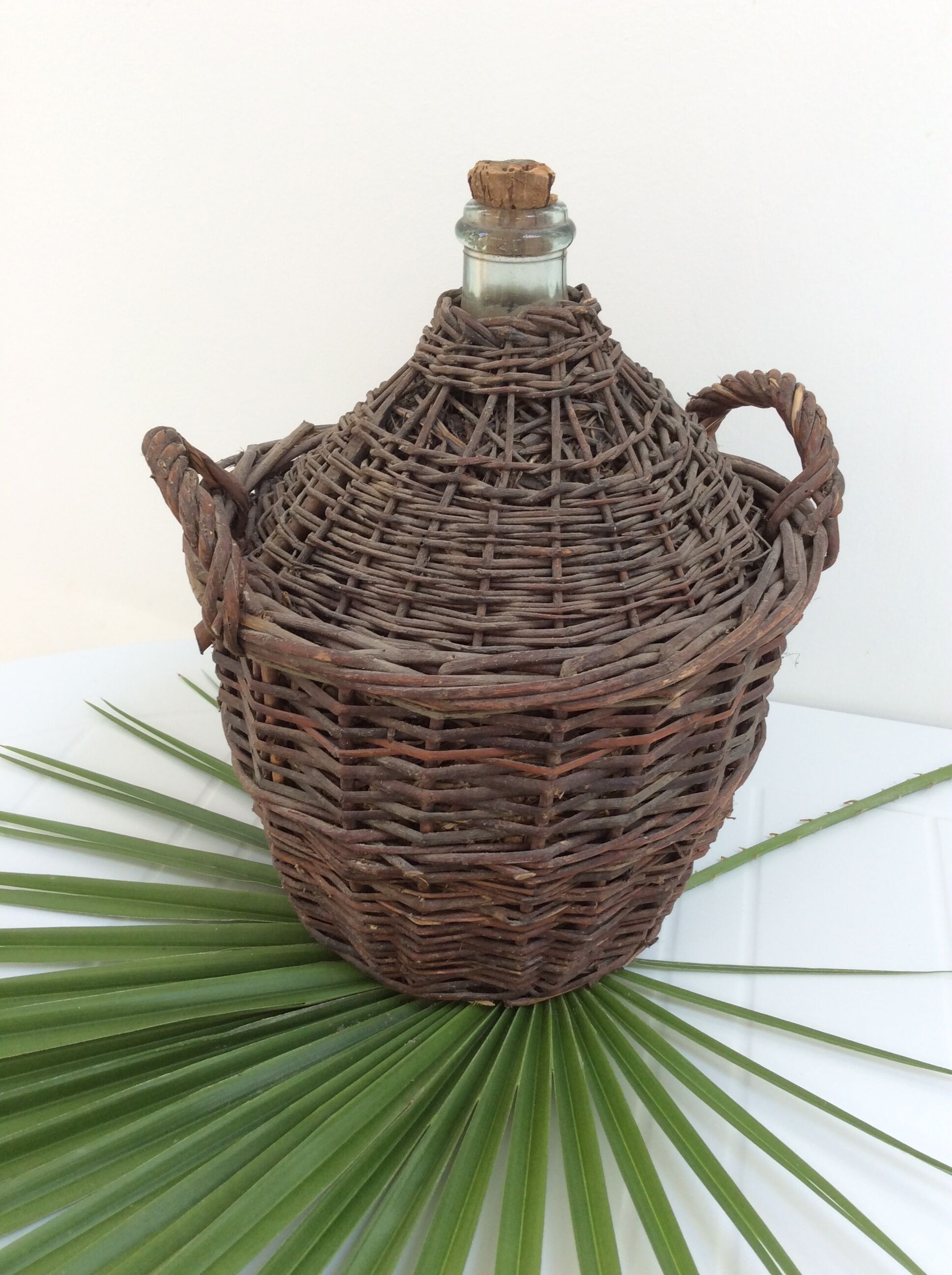 Demijohn in her braided wicker basket