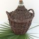 Demijohn in her braided wicker basket