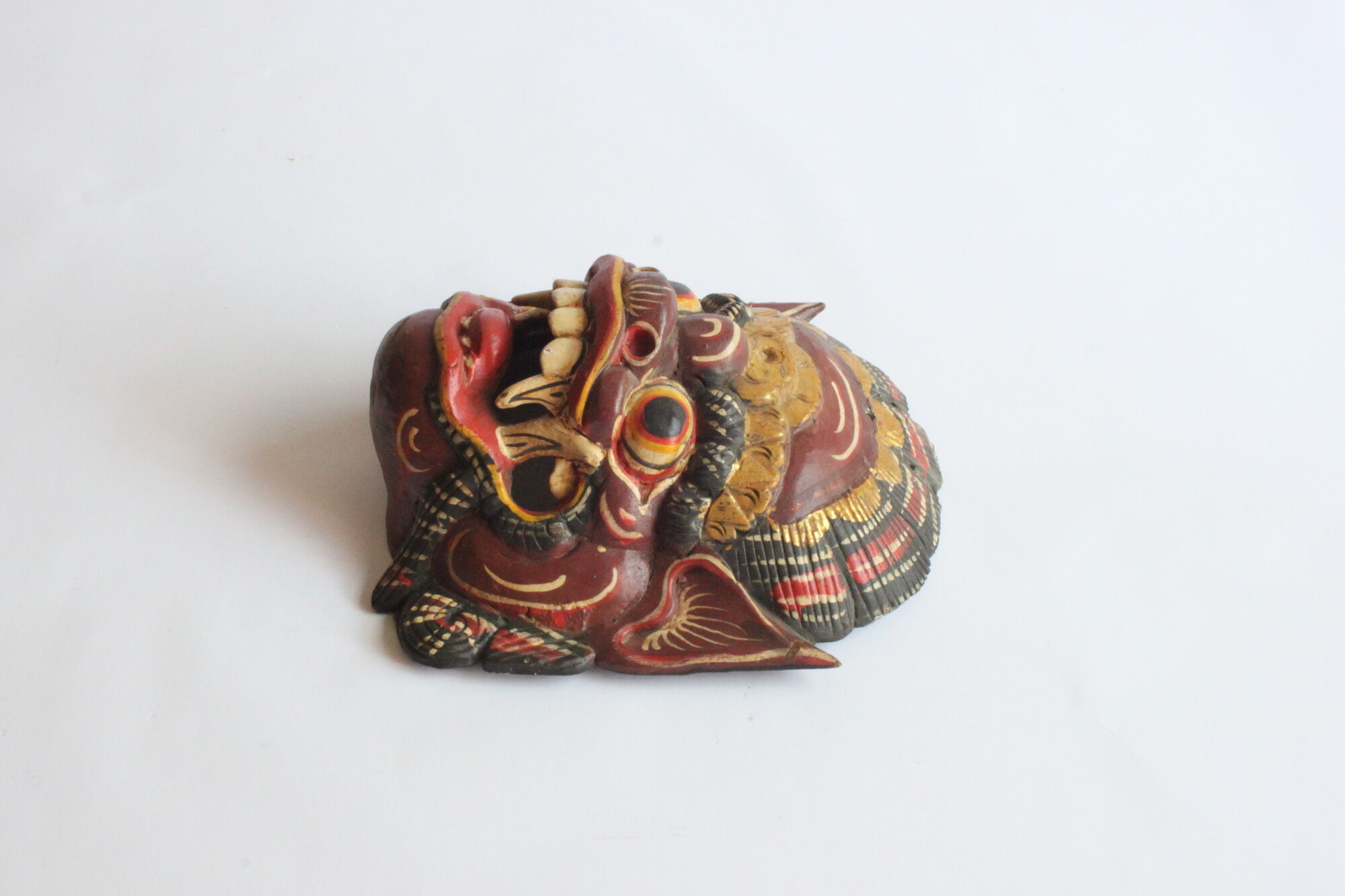 Two polychrome painted and gold leaf gilded Barong dance masks from Bali, Indonesia.