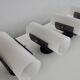 Set of four wall lights in white plexiglass and perforated black metal.