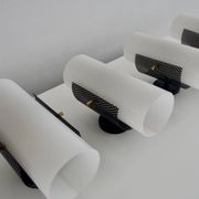 Set of four wall lights in white plexiglass and perforated black metal.