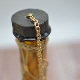 Amber decanter with wicker and golden chain