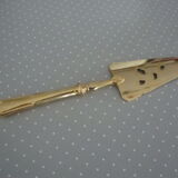 Golden metal pie shovel