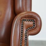 Cognac-colored leather wingback chair in English style