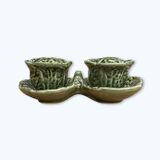 Salt and pepper shakers in the shape of a cabbage leaf.