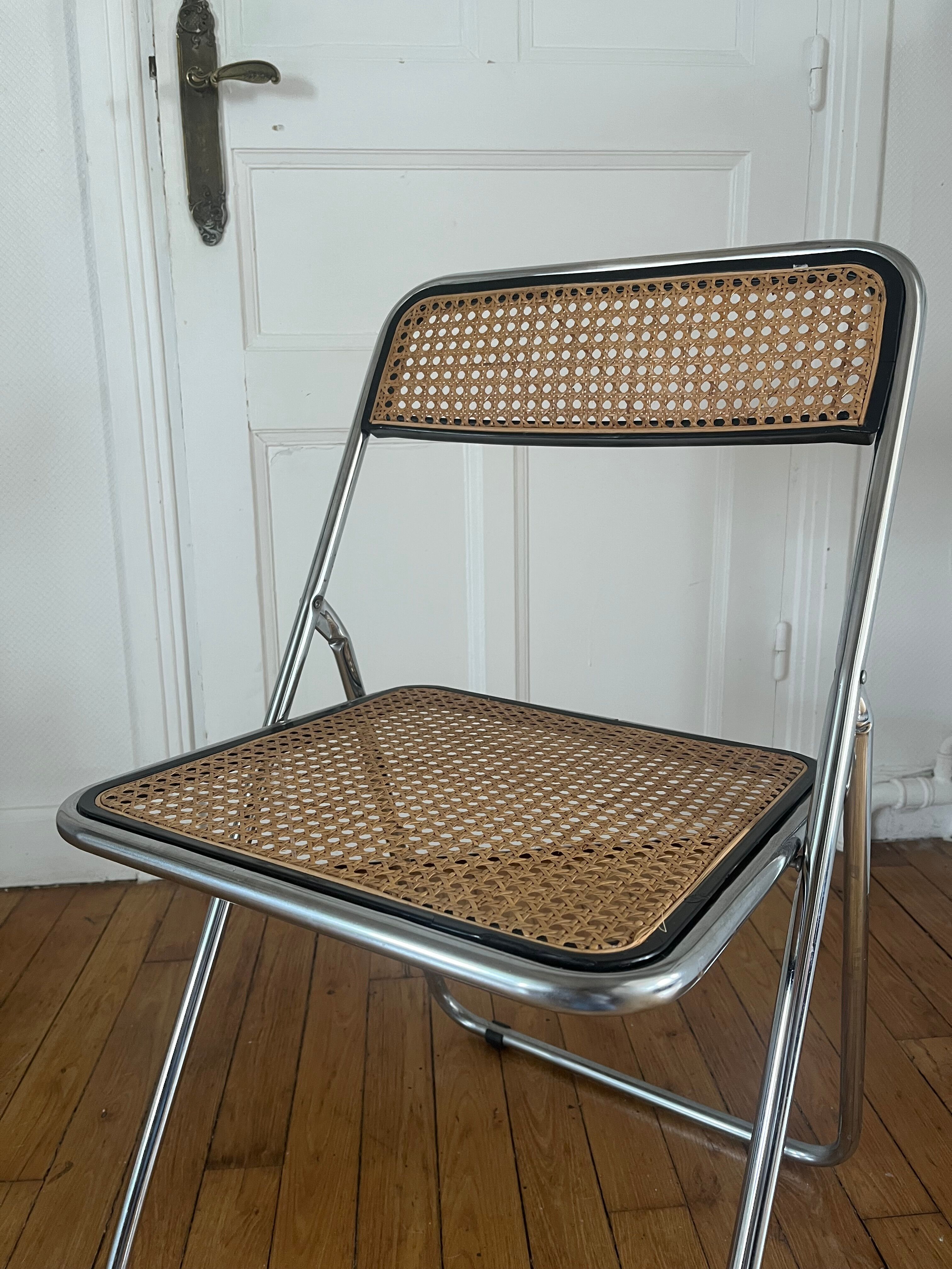 Vintage folding chair in metal and cane.