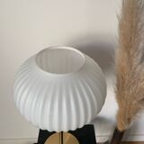 Table lamp with a white striped globe, origami style and a golden foot