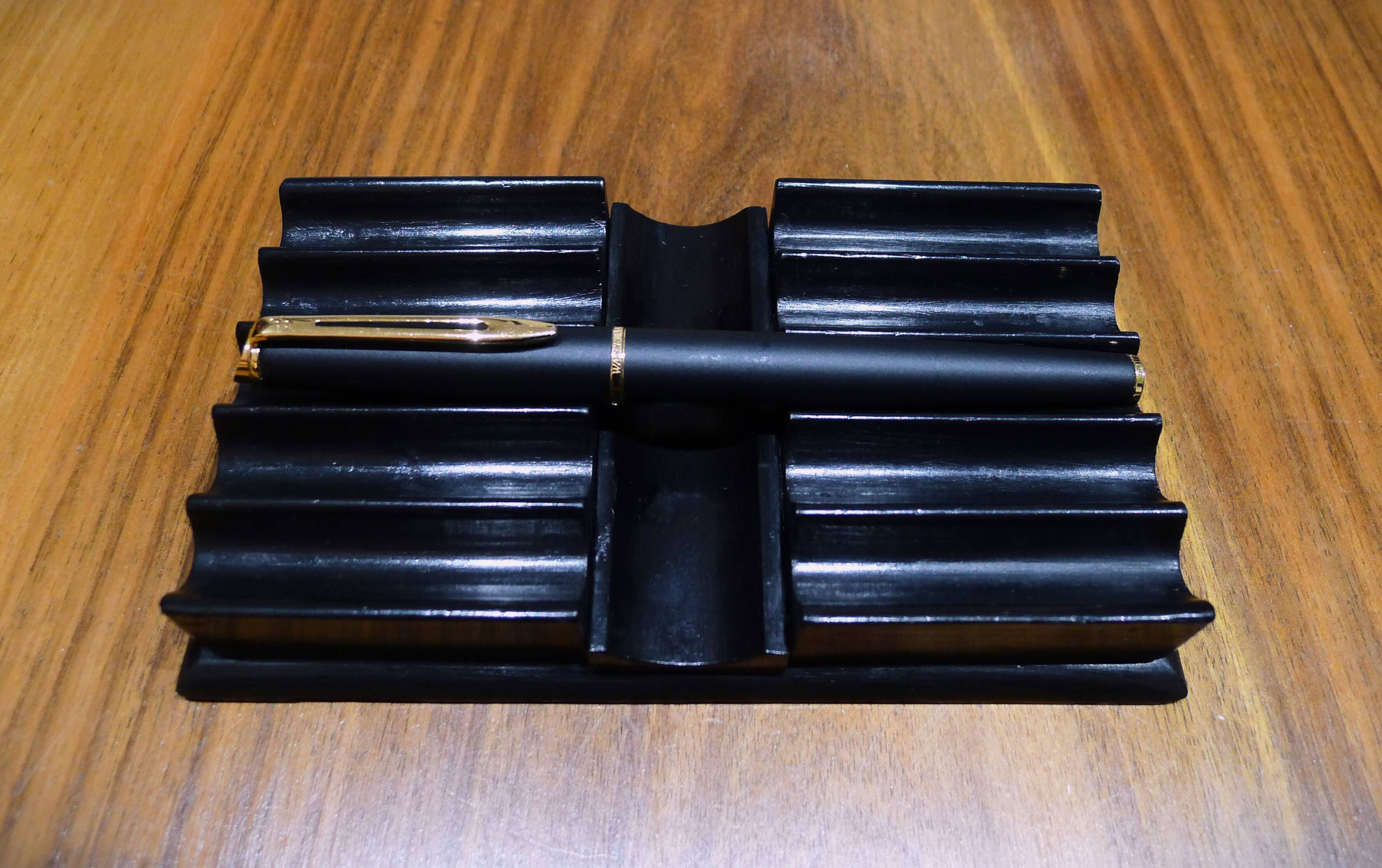 Old pen holder in black wood
