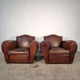Important pair of Havana leather club armchairs, moustache models, mid-20th century.