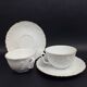 Tharaud Limoges white porcelain cups and saucers with gold relief