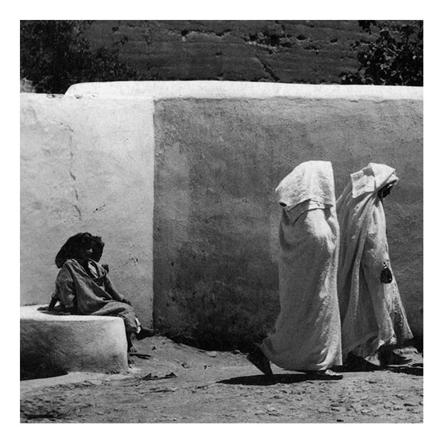 Women in white under the ramparts of Fez around 1930
