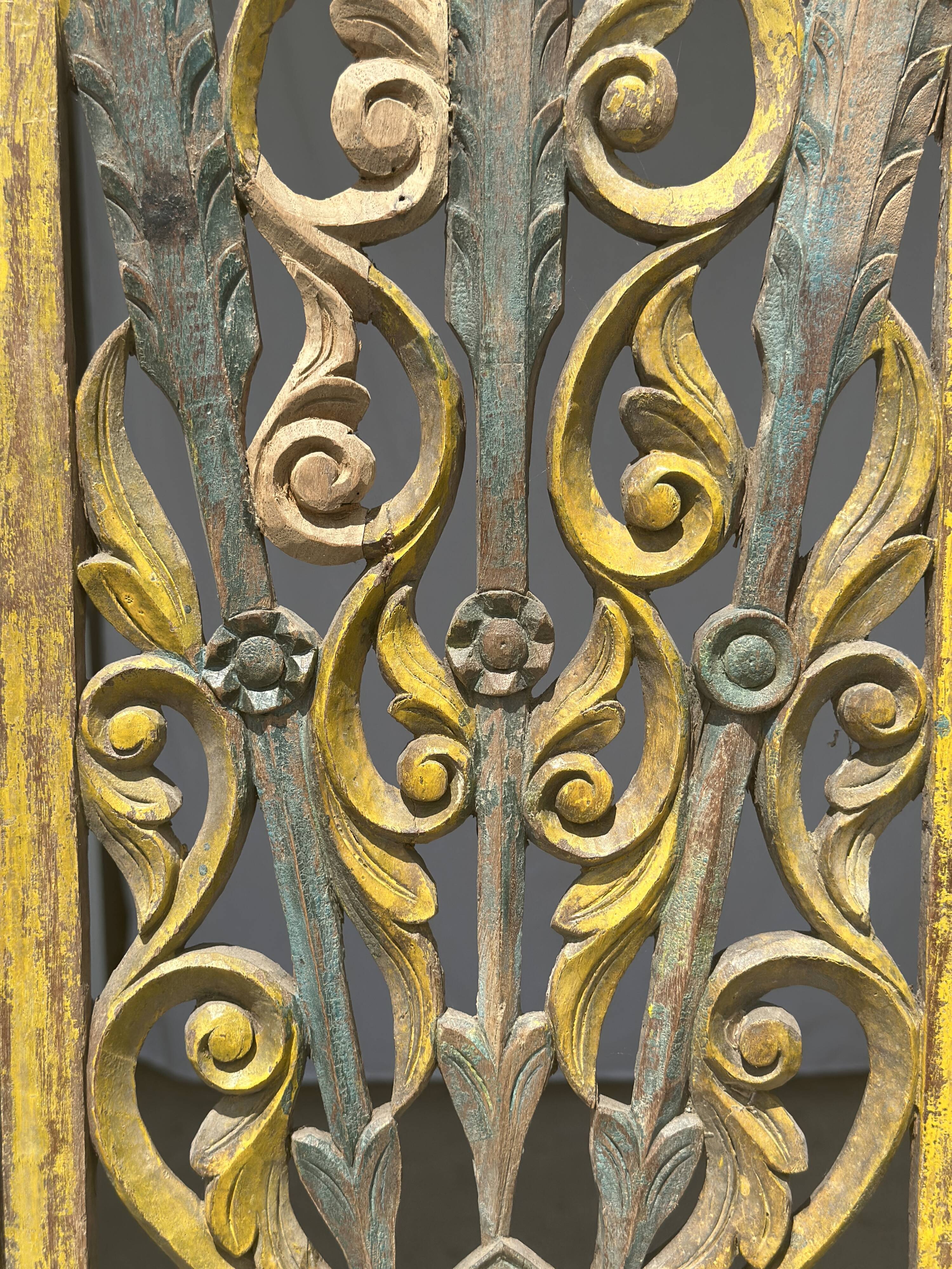 Rectangular Indonesian construction element with blue and yellow plant in carved wood