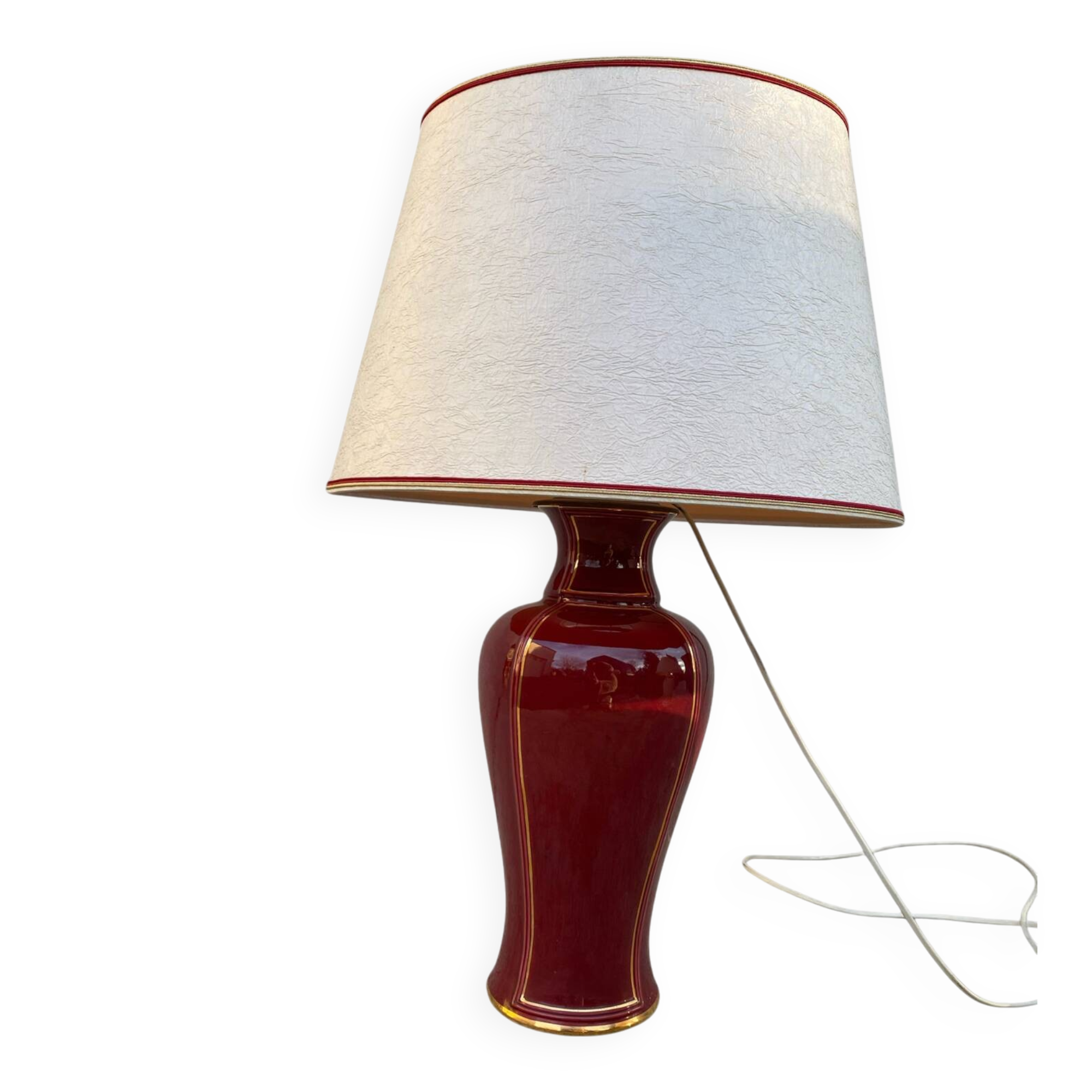 Large burgundy and gold table lamp in vase style.