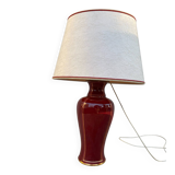 Large burgundy and gold table lamp in vase style.