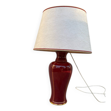 Large burgundy and gold table lamp in vase style.