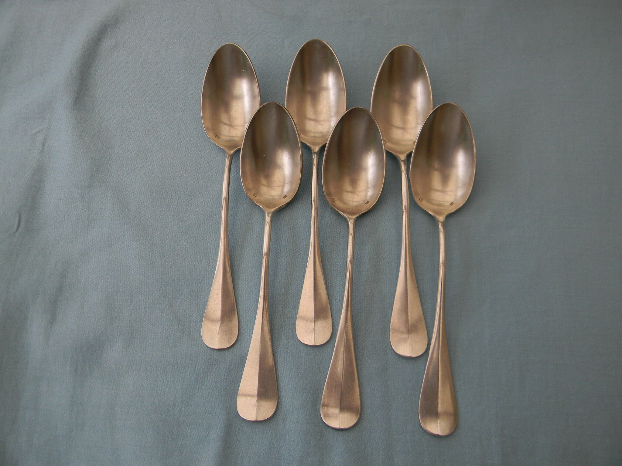 Set of 6 silver metal dessert spoons.