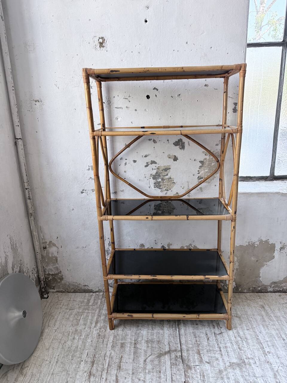 Rattan bookshelf and black glasses