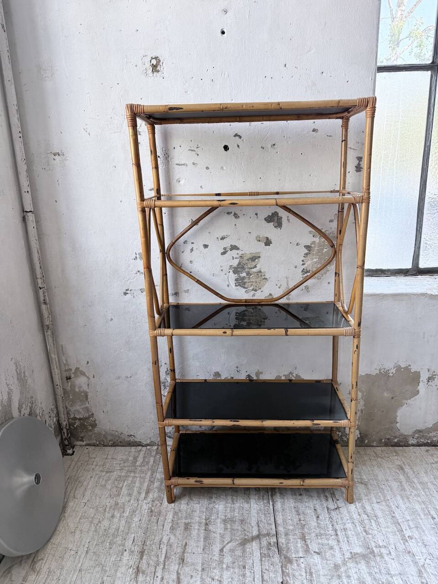 Rattan bookshelf and black glasses
