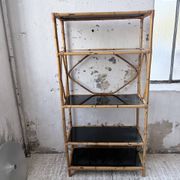 Rattan bookshelf and black glasses