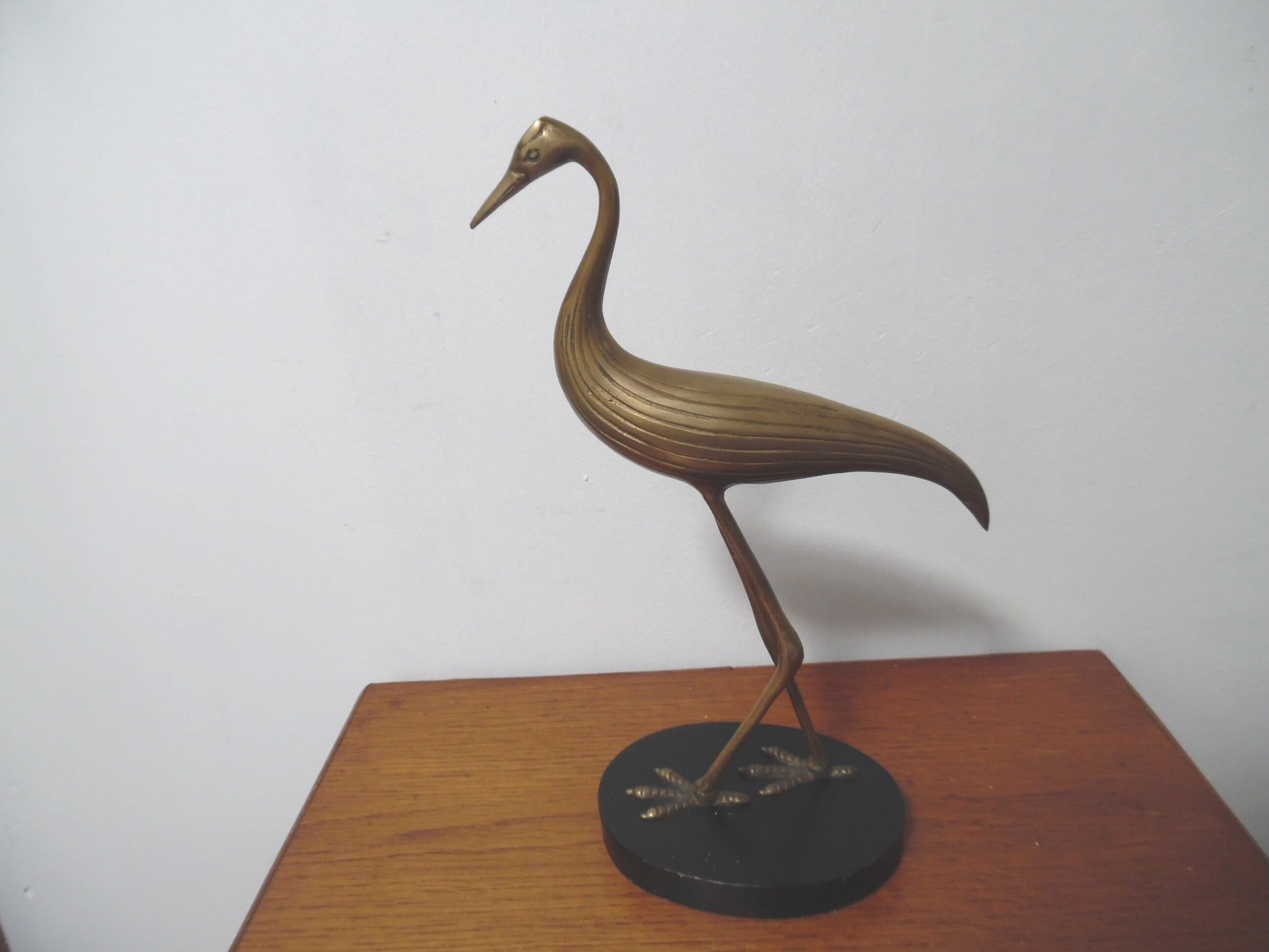 Brass heron standing