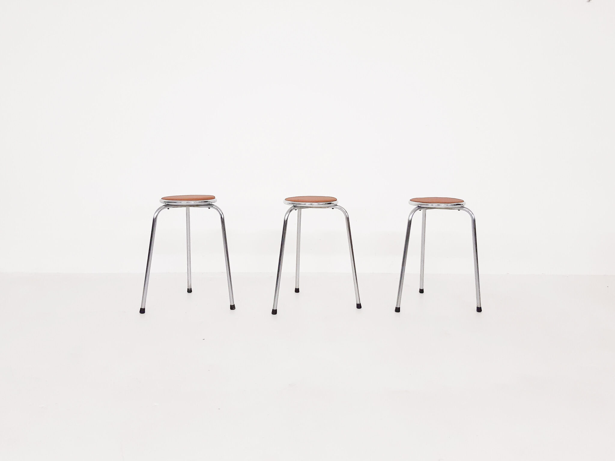 Set of 3 chrome stools with cognac leather seating, 1960's
