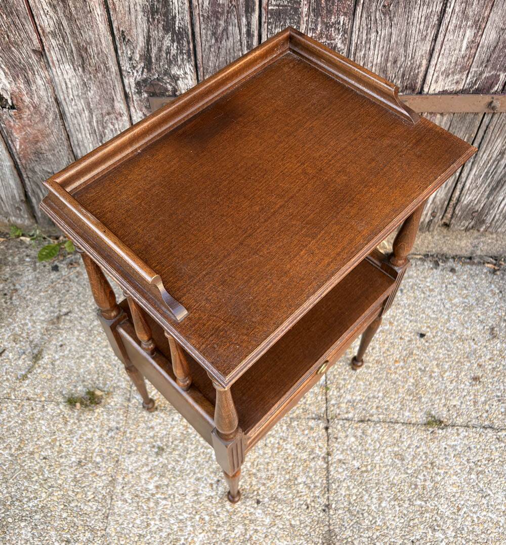 Solid wood bedside table with turned columns, early 20th century.