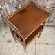 Solid wood bedside table with turned columns, early 20th century.