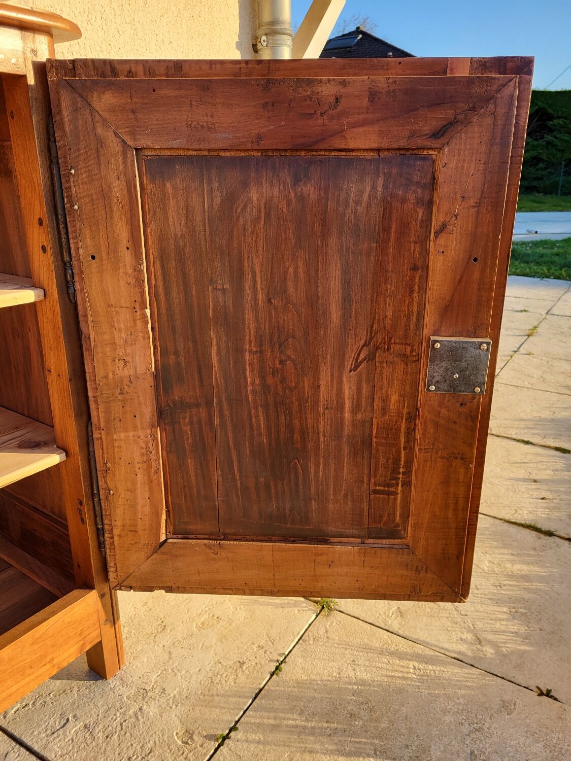 Furniture with a cherry wood door.