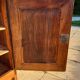 Furniture with a cherry wood door.