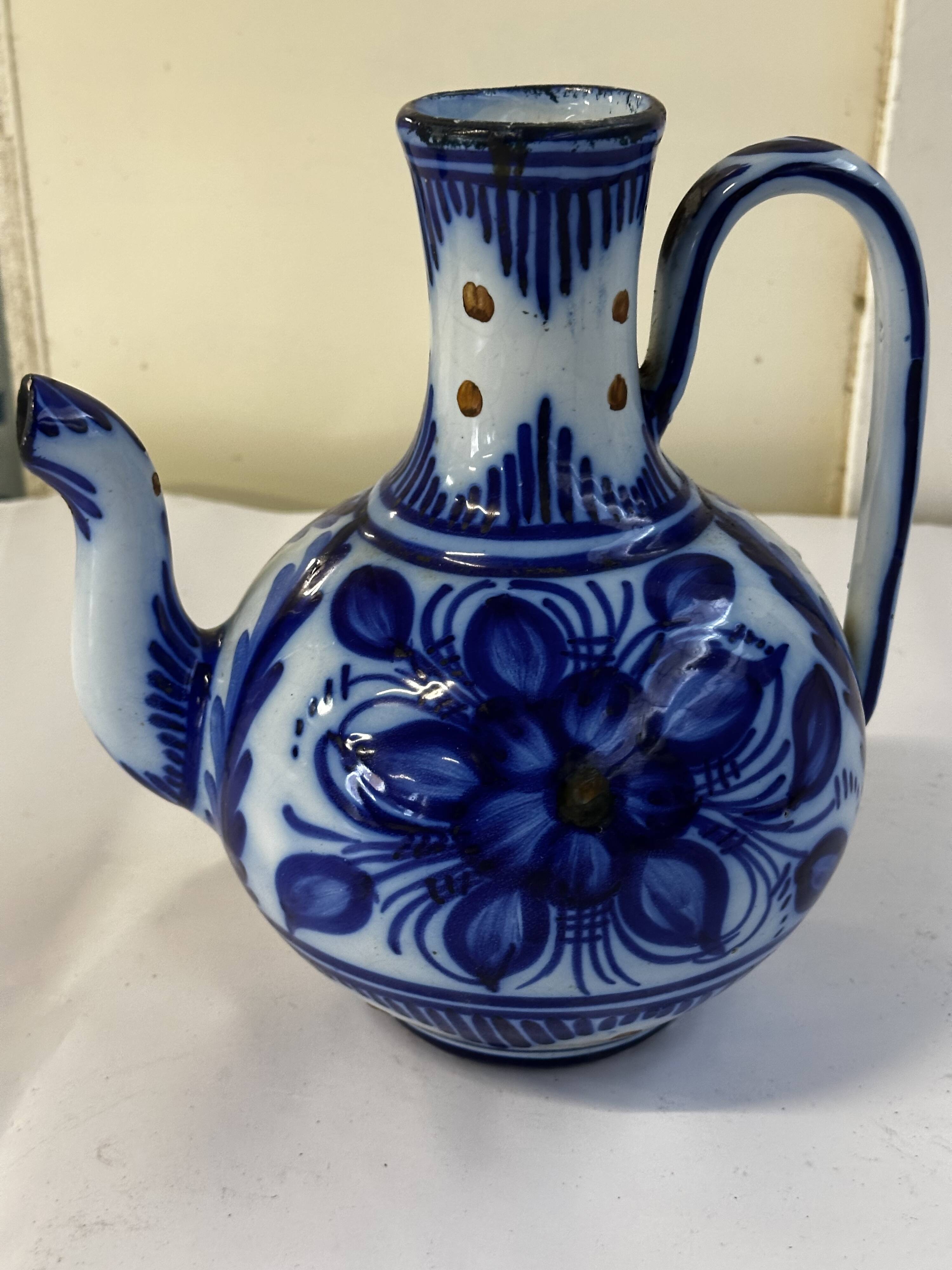 Glazed ceramic carafe with floral decoration
