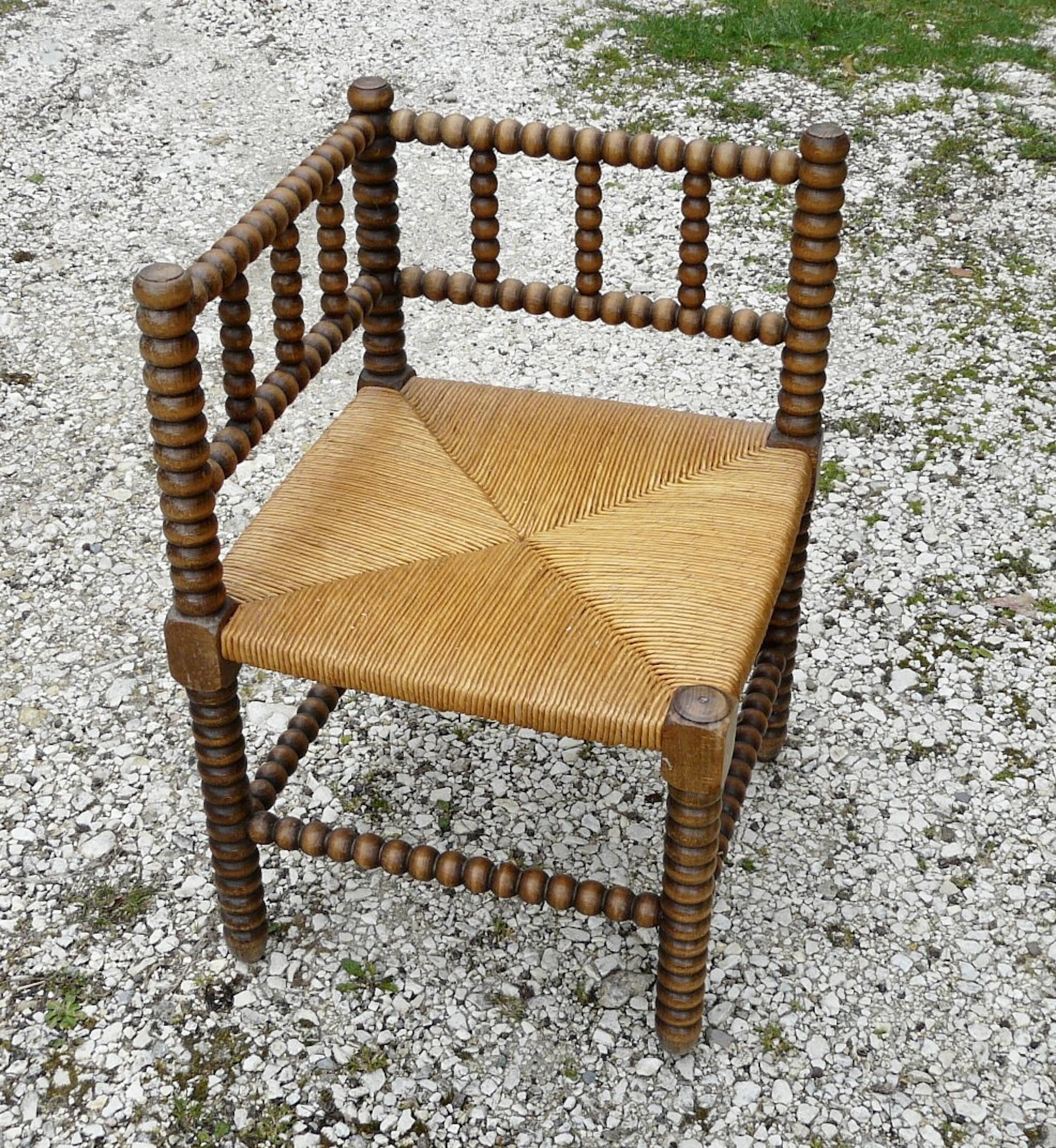 Turned wood straw corner armchair