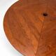 Large round dining table with black blade legs.
