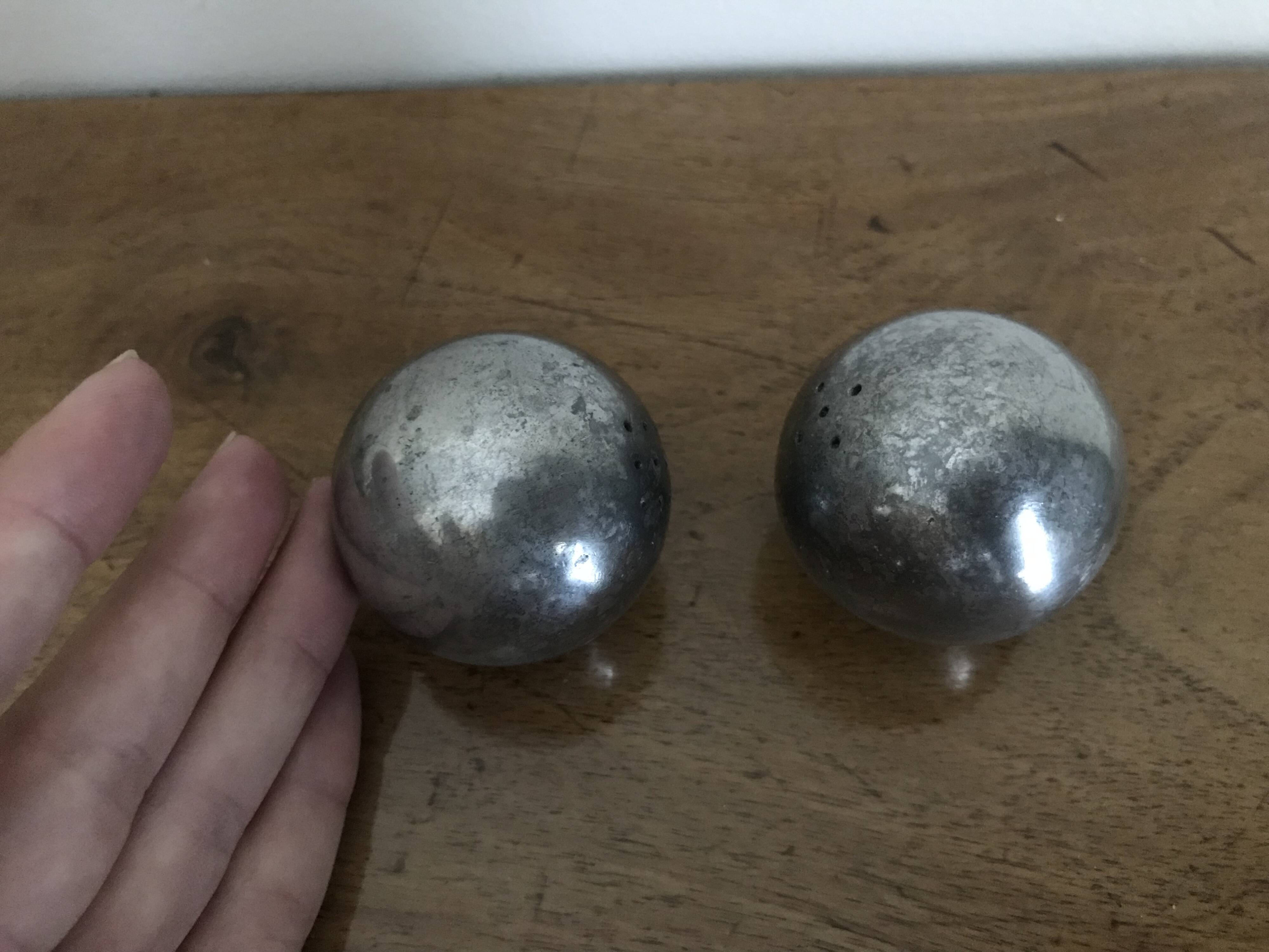 Brutalist salt and pepper ball in cast steel