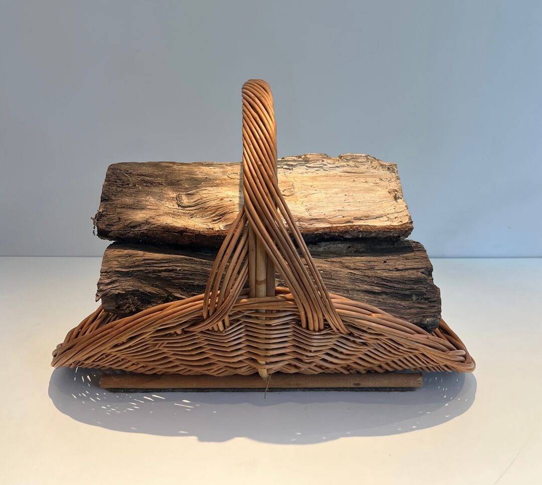 Woven Rattan Log Holder in a Semi-Round Shape with a Central Arched Handle.