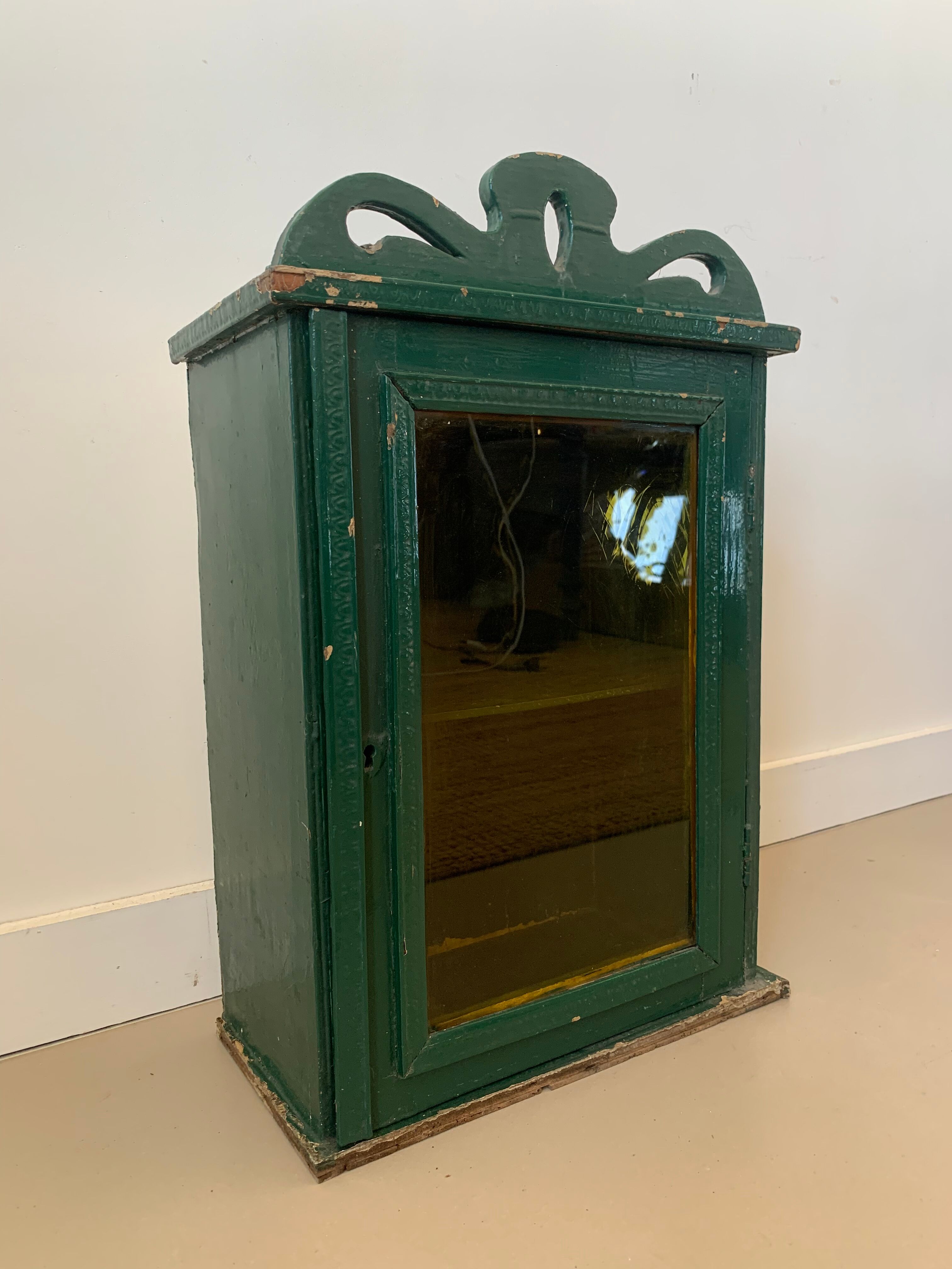 Wall vitrin with pediment