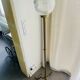 Brass floor lamp with a round glass globe