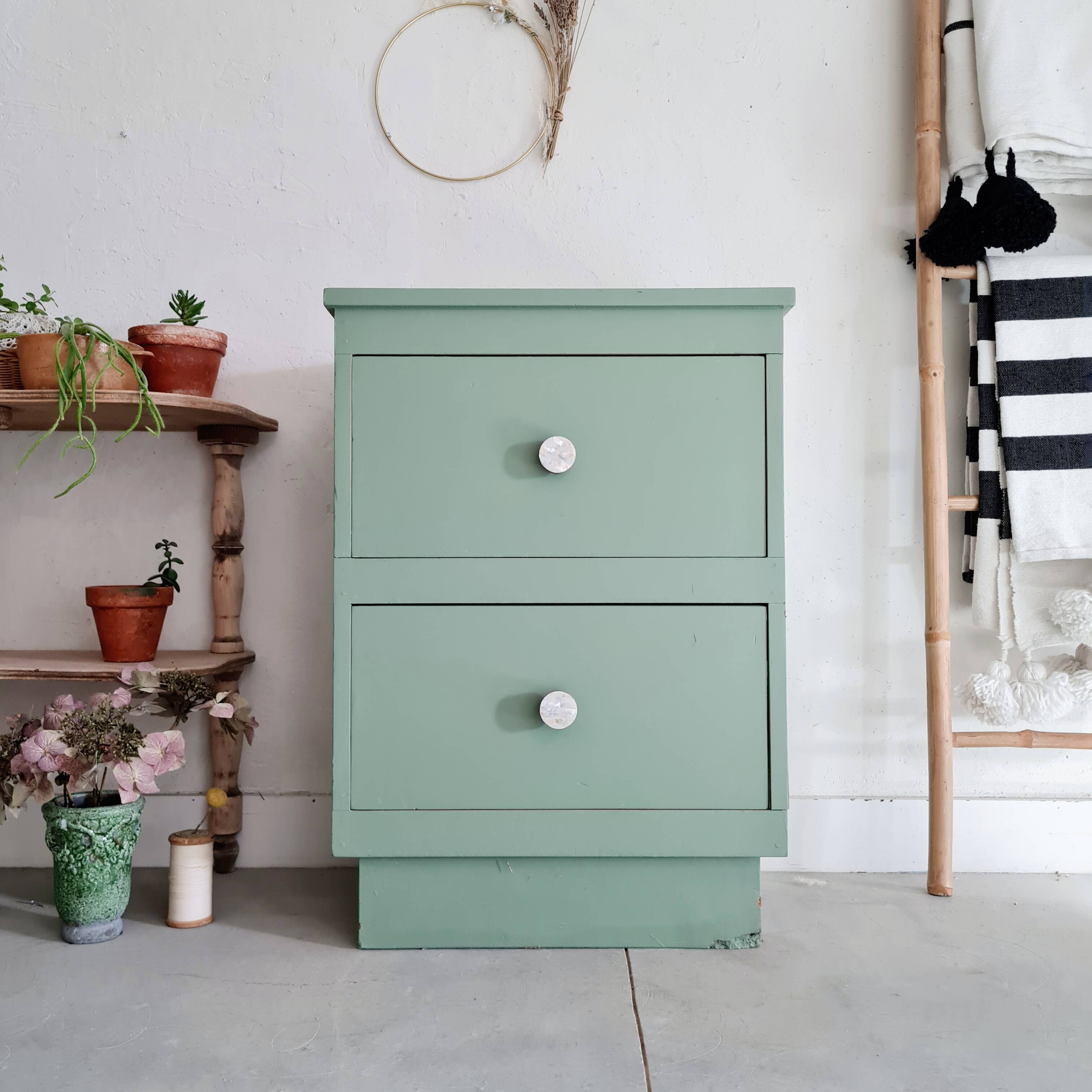 Old chest of drawers with two green drawers