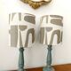 Pair of wooden lamps with custom modernist lampshades.