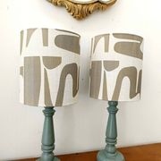 Pair of wooden lamps with custom modernist lampshades.